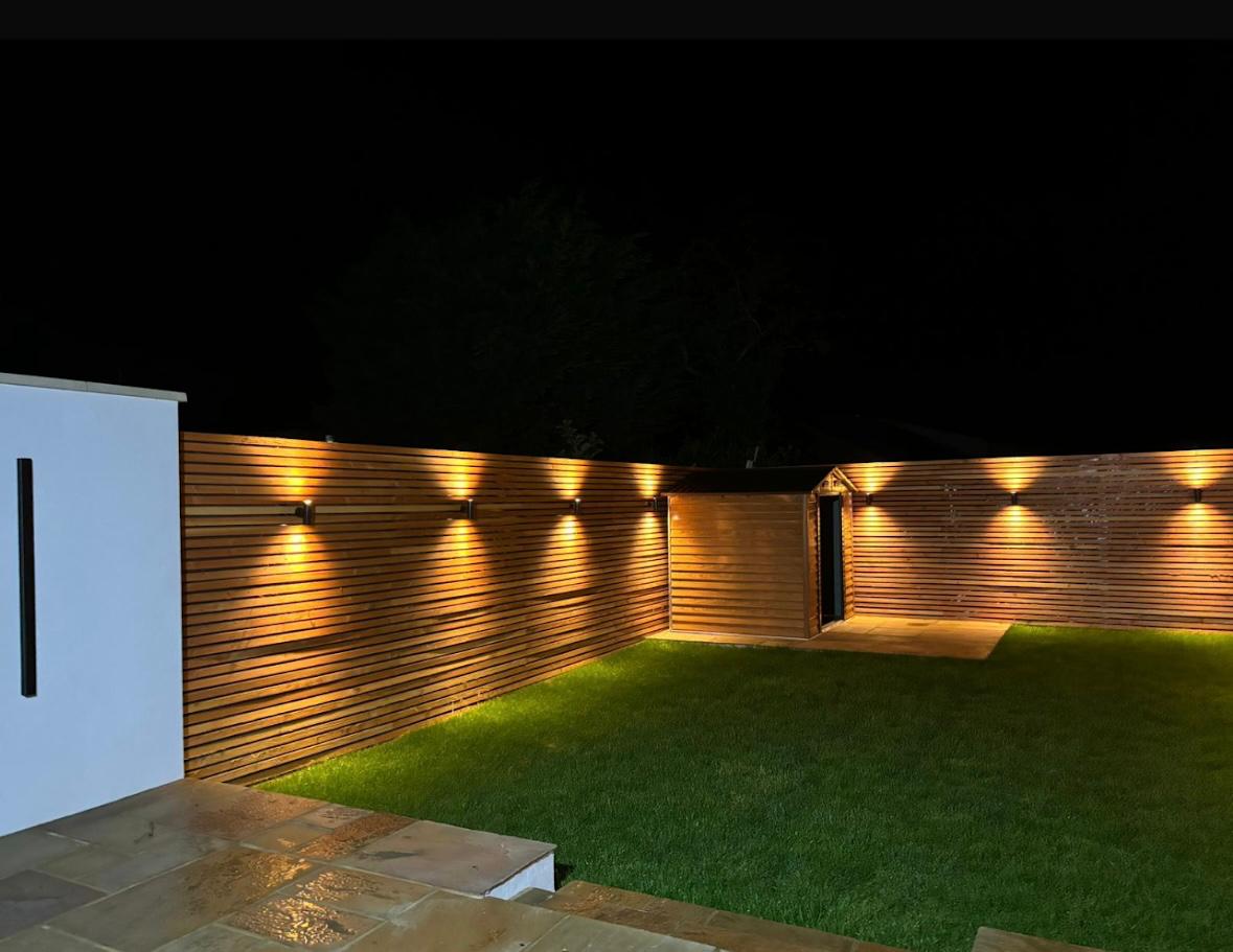 Professional garden lighting installation at night
